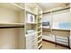 Spacious walk-in closet with custom shelving and drawers provides ample storage space at 3087 Cherry Ln, Clearwater, FL 33759