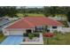 Aerial view of a charming home with a red roof and an attached two-car garage at 3092 Hillside Ln, Safety Harbor, FL 34695