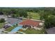 Aerial view of the house with a red roof, green surroundings, and a long driveway at 3092 Hillside Ln, Safety Harbor, FL 34695