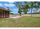 Lush backyard with a pristine pool, screened enclosure, and secure privacy fence, blending recreation and serenity at 3092 Hillside Ln, Safety Harbor, FL 34695