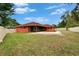 Wide backyard view with a pool, enclosed patio, grassy area, and a well-maintained fence at 3092 Hillside Ln, Safety Harbor, FL 34695