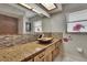 Bathroom with a unique vanity, granite countertop, mosaic tile backsplash, and tiled shower at 3092 Hillside Ln, Safety Harbor, FL 34695