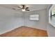 Bright and airy bedroom with laminate flooring, ceiling fan, closet, and window with natural light at 3092 Hillside Ln, Safety Harbor, FL 34695