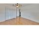 Bright bedroom with light wood floors, closet and ceiling fan at 3092 Hillside Ln, Safety Harbor, FL 34695