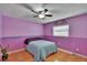 Cozy bedroom with colorful walls, laminate floors, a ceiling fan, and ample natural light at 3092 Hillside Ln, Safety Harbor, FL 34695