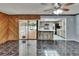 Open-concept living room leading to the renovated kitchen with stainless steel appliances and updated counters at 3092 Hillside Ln, Safety Harbor, FL 34695