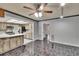 Open-concept living area with breakfast bar features tile floors, modern appliances, and stylish cabinetry at 3092 Hillside Ln, Safety Harbor, FL 34695