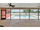 Enclosed patio with view of a private backyard pool and lush landscaping at 3092 Hillside Ln, Safety Harbor, FL 34695