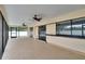 Spacious enclosed patio with dual fans and sliding doors at 3092 Hillside Ln, Safety Harbor, FL 34695