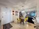Bright dining area with mirrored wall, contemporary chandelier, and seating for four around a glass table at 3188 Lake Pine S Way # B1, Tarpon Springs, FL 34688