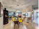 Dining area featuring glass table, modern lighting, and a mirrored wall that expands the sense of space at 3188 Lake Pine S Way # B1, Tarpon Springs, FL 34688
