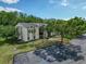 Apartment building with mature trees and well-maintained landscaping, complemented by ample parking at 3188 Lake Pine S Way # B1, Tarpon Springs, FL 34688