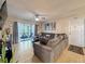 Cozy living room with a comfortable sectional, sliding glass doors to the balcony, and stylish decor at 3188 Lake Pine S Way # B1, Tarpon Springs, FL 34688