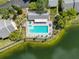Top-down aerial view of a condo community pool and surrounding lake at 3188 Lake Pine S Way # B1, Tarpon Springs, FL 34688