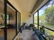 Enclosed patio featuring views of the lush landscape and providing a tranquil outdoor living space at 3188 Lake Pine S Way # B1, Tarpon Springs, FL 34688
