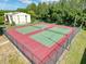 Aerial view of tennis courts, completely fenced and professionally maintained, for community resident enjoyment at 3188 Lake Pine S Way # B1, Tarpon Springs, FL 34688