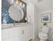 Elegant bathroom with a stylish mirror, white vanity, marble countertop, and herringbone backsplash at 3505 N Dartmouth Ave, Tampa, FL 33603