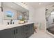 Elegant bathroom featuring double vanity, granite countertops, a large mirror, and a tiled walk-in shower at 3505 N Dartmouth Ave, Tampa, FL 33603