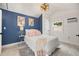 Stylish bedroom with blue accent wall, light fixture, and bright decor at 3505 N Dartmouth Ave, Tampa, FL 33603