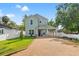 Charming two-story home featuring a gravel driveway, lush green lawn, and a welcoming covered entrance at 3505 N Dartmouth Ave, Tampa, FL 33603