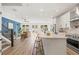 Open-concept kitchen and living area, featuring white cabinetry and a modern island at 3505 N Dartmouth Ave, Tampa, FL 33603