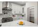 Modern kitchen with stainless appliances, white cabinets, and a stylish backsplash at 3505 N Dartmouth Ave, Tampa, FL 33603