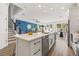 Spacious kitchen featuring white cabinets, stainless steel appliances and stylish black hardware at 3505 N Dartmouth Ave, Tampa, FL 33603
