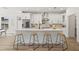 Open-concept kitchen with a large island, barstool seating, and stainless steel appliances at 3505 N Dartmouth Ave, Tampa, FL 33603