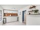 Charming kitchenette with ample cabinet space and access to a bathroom at 3505 N Dartmouth Ave, Tampa, FL 33603