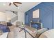Inviting living room featuring modern decor, a striking blue accent wall, and staircase at 3505 N Dartmouth Ave, Tampa, FL 33603