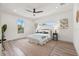 Sunlit main bedroom features wood-look floors, neutral decor, and a view of the lush outdoors at 3505 N Dartmouth Ave, Tampa, FL 33603