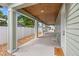 A spacious covered porch with a concrete floor and wood paneled ceiling at 3505 N Dartmouth Ave, Tampa, FL 33603