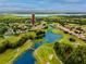 Aerial view highlighting the community's golf course, water features, and residential layout at 3726 Rain Tree Ct, Palm Harbor, FL 34685