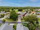 Aerial view of a single-Gathering home nestled within a lush, green, planned community at 3726 Rain Tree Ct, Palm Harbor, FL 34685