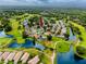 Drone shot showing a residential home nestled amid green fairways, water, and mature trees at 3726 Rain Tree Ct, Palm Harbor, FL 34685