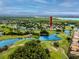 A stunning aerial view of a golf community surrounded by water, showcasing a desirable lifestyle at 3726 Rain Tree Ct, Palm Harbor, FL 34685