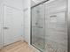 Bathroom featuring a glass shower with decorative tile and a neutral color palette at 3726 Rain Tree Ct, Palm Harbor, FL 34685