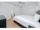 Bright bedroom featuring wood flooring, a ceiling fan, and access to an ensuite bathroom for added convenience at 3726 Rain Tree Ct, Palm Harbor, FL 34685