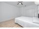 Bright bedroom featuring a ceiling fan, a large closet, and light, wood-look flooring at 3726 Rain Tree Ct, Palm Harbor, FL 34685