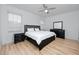 Bedroom featuring a ceiling fan, wood-look floors and lots of natural light at 3726 Rain Tree Ct, Palm Harbor, FL 34685