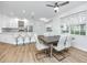 Bright open-concept dining room adjacent to modern kitchen with eat-in bar at 3726 Rain Tree Ct, Palm Harbor, FL 34685