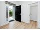 Bright entryway with wood-look floors and a modern black front door at 3726 Rain Tree Ct, Palm Harbor, FL 34685