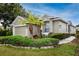 Charming single-story home featuring mature landscaping and a two-car garage at 3726 Rain Tree Ct, Palm Harbor, FL 34685