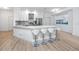 Bright, modern kitchen with a large center island and seating for four at 3726 Rain Tree Ct, Palm Harbor, FL 34685