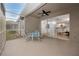 Covered outdoor patio with ceiling fan and furniture, seamlessly connected to interior living space at 3726 Rain Tree Ct, Palm Harbor, FL 34685
