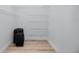 Spacious walk-in closet with wire shelving and room for suitcases, providing ample storage solutions at 3726 Rain Tree Ct, Palm Harbor, FL 34685