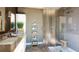 Modern bathroom featuring a double vanity, sleek fixtures, a glass-enclosed shower, and stylish shelving at 4723 W Price Ave # 2, Tampa, FL 33611