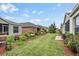 Landscaped backyard with grass, mulch and plants at 5116 Gato Del Sol Cir, Wesley Chapel, FL 33544