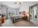 Bedroom with carpet, ceiling fan, closet and large window dressed with blue curtains at 5116 Gato Del Sol Cir, Wesley Chapel, FL 33544