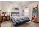 Inviting bedroom features a bed with a gray headboard, colorful quilts, and a decorative ladder at 5116 Gato Del Sol Cir, Wesley Chapel, FL 33544